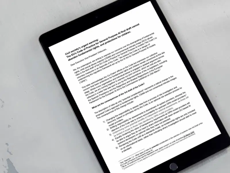 A tablet lying on a light grey surface displays a formal letter titled "Civil society’s urgent warning: The EU's Code of Practice for General Purpose AI final draft cannot abandon fundamental rights, and protections for children." The letter is addressed to Executive Vice-President Virkkunen and outlines concerns from various organisations about downgrading key protections in the AI Code.